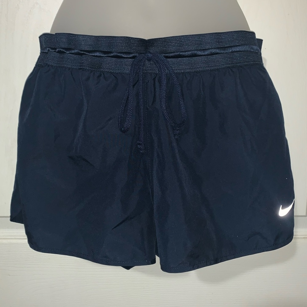 Nike dri-fit Navy blue shorts with a bit of green.